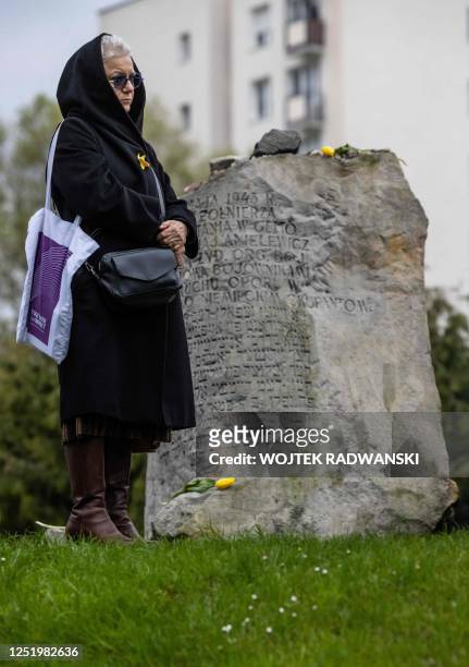 Woman stands next to the Anielewicz bunker memorial as she takes part in unofficial ceremonies to mark the 80th anniversary of the start of the...