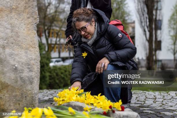 Woman reacts next to the Anielewicz bunker memorial as she takes part in unofficial ceremonies to mark the 80th anniversary of the start of the...