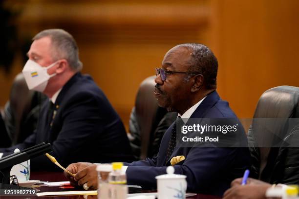 Gabonese President Ali Bongo Ondimba talks with Chinese President Xi Jinping during a meeting at the Great Hall of the People on April 19, 2023 in...