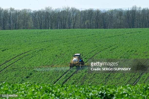 Farmer rides a floater truck spraying fertilizers on a farm in Kyiv region on April 19, 2023. - European Commission president Ursula von der Leyen on...