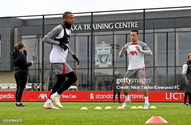 Joel Matip and Thiago Alcantara of Liverpool during a training session at AXA Training Centre on April 19, 2023 in Kirkby, England.