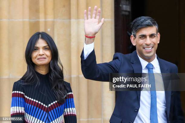 Britain's Prime Minister Rishi Sunak , flanked by his wife Akshata Murty , waves as he leaves on the final day of a conference to mark the 25th...