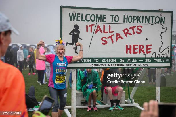 Hopkinton, MA A woman has her picture taken prior to the start of the 127th Boston Marathon.
