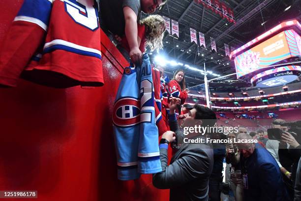 Carey Price of the Montreal Canadiens signs autographs for fans after the NHL game against the Boston Bruins at the Centre Bell on April 13, 2023 in...