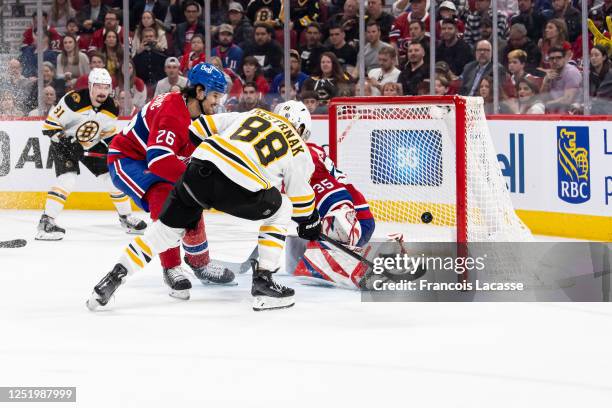 David Pastrnak of the Boston Bruins scores a goal against Sam Montembeault of the Montreal Canadiens during the third period in the NHL game at the...