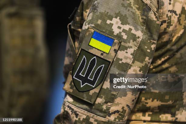 Ukrainian flag and Coat of Arms emblems are seen on a military uniform during the 35th anniversary of 'International March of the Living' at the...