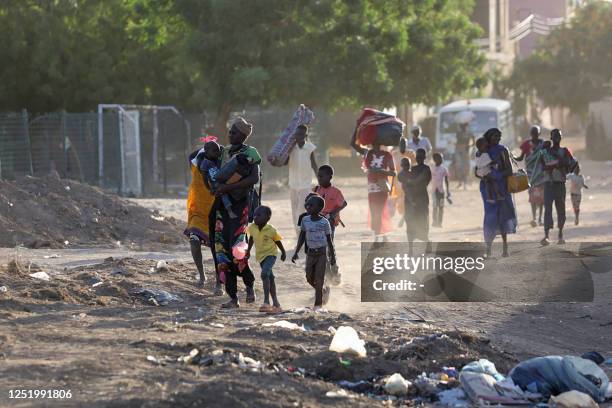 People flee their neighbourhoods amid fighting between the army and paramilitaries in Khartoum on April 19 following the collapse of a 24-hour truce.