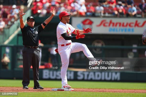 Willson Contreras of the St. Louis Cardinals celebrates after hitting an RBI double against the Arizona Diamondbacks as umpire Manny Gonzalez calls...