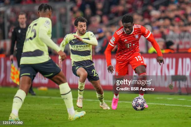 Alphonso Davies of FC Bayern Munchen battles for the ball with Bernardo Silva of Manchester City and Manuel Akanji of Manchester City during the UEFA...