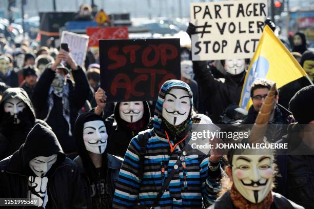 Demonstrators wearing Anonymous Guy Fawkes masks attend a protest against the Anti-Counterfeiting Trade Agreement on February 11, 2012 in Paris....