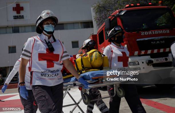 Members of the Mexican Red Cross attend to a person who was rescued by rappelling during the First National Drill 2023 in Mexico, on april 19 where...