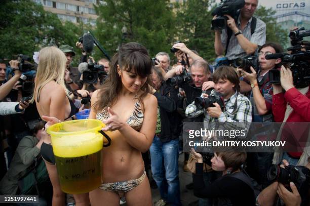 Members of an Internet community supporting Russia's President Dmitry Medvedev carry pails of beer as part of a performance to discourage Russian...