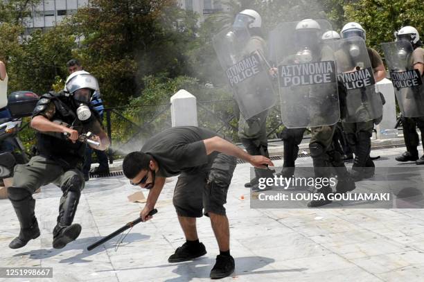 Greek police sprays a protestor with tear gas during clashes while thousands demonstrated in Athens and major cities on June 29, 2010 as the country...