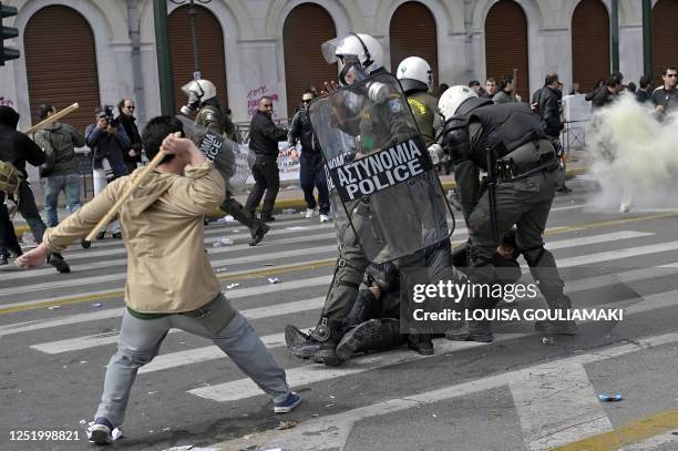 Demonstrators clash with police outside the Greek parliament in Athens on March 5, 2010. Greek police fired tear gas and clashed with protesters...