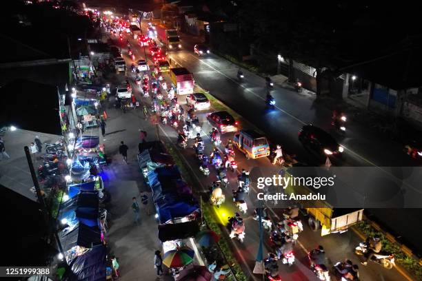 An aerial view of the hundreds of motorbikes and cars crowding the streets during a homecoming trip to celebrate Eid al-Fitr at Jomin intersection in...