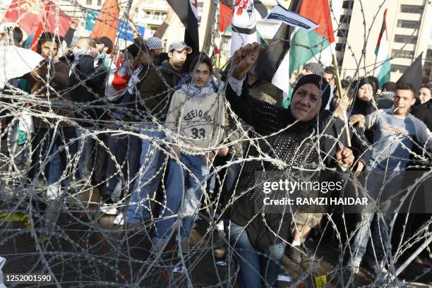 Lebanese and Palestinian protestors attempt to remove barbed wire protecting the Egyptian Embassy in Beirut during a protest on December 28, 2008...