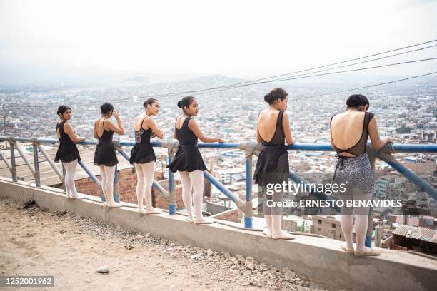 Ballet students prepare before performing at the San Genaro neighborhood in the Chorrillos district, south of Lima, on April 1, 2023. - At an arid...