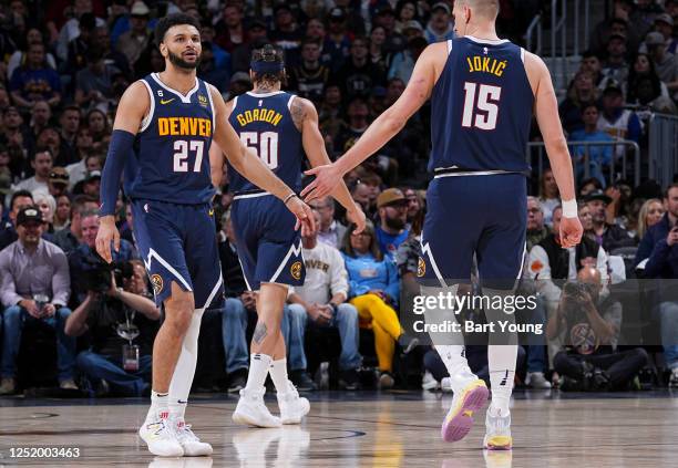 Jamal Murray of the Denver Nuggets high fives Nikola Jokic during the game against the Minnesota Timberwolves during Round One Game Two of the 2023...