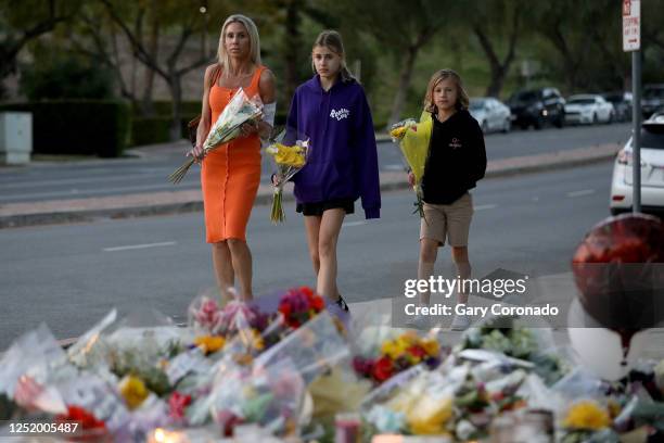 Tara Abikoff and her two children Malibu center, and Zuma visit a memorial for Wesley Welling in front of Westlake High School on Wednesday, April...