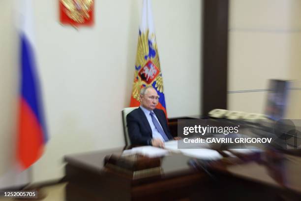 Russian President Vladimir Putin chairs a meeting with members of the government via a video conference at the Novo-Ogaryovo state residence, outside...