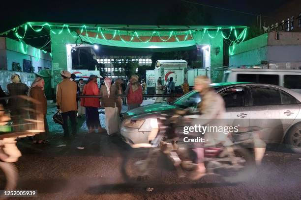 Yemenis wait outside a hospital in Sanaa early on April 20 after a stampede during charity distribution left at least 85 people dead and over 300...