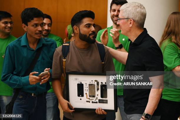 Chief Executive Officer of Apple Tim Cook talks with Apple enthusiast during the opening of New Delhi's first Apple retail store at a mall in New...
