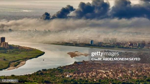 This video grab taken from AFPTV video footage on April 19 shows an aerial view of black smoke covering the sky above the capital Khartoum....