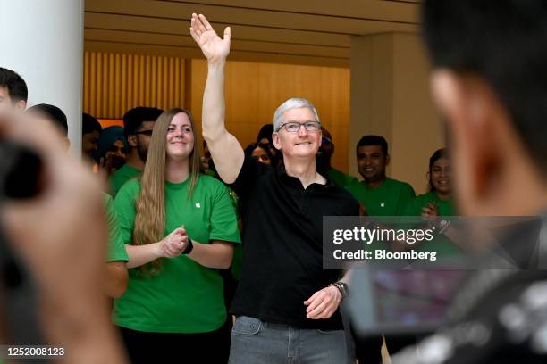 Tim Cook, chief executive officer of Apple Inc., center, greets customers during the opening of the new Apple Saket store in New Delhi, India, on...