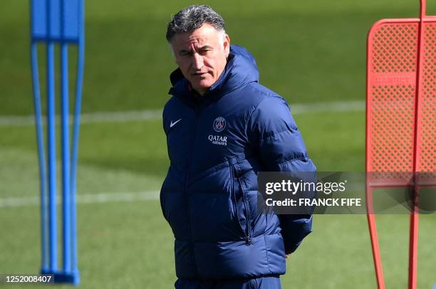 Paris Saint-Germain's French head coach Christophe Galtier looks on during a training session at club's training ground in Saint-Germain-en-Laye,...