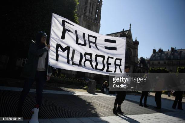 Animal rights activists from the Collectif SIPE and the Coalition to Abolish Fur Trade hold a rally to protest against the use of animal fur near the...