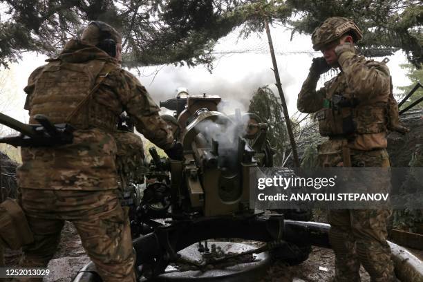 Ukrainian paratroopers fire an L119 howitzer towards Russian positions at a front line in the Lugansk region on April 20 amid the Russian invasion of...