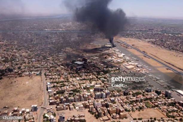 This image grab taken from AFPTV video footage on April 20 shows an aerial view of black smoke rising above the Khartoum International Airport amid...