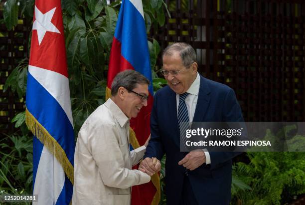 Russian Foreign Minister Sergey Lavrov and Cuba's Minister of Foreign Affairs, Bruno Rodriguez, shake hands during a meeting in Havana on April 20,...