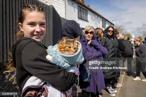 Tiger Lillie the cat joined mourners gathered outside the Walnut Tree Inn in Aldington to pay respects to Paul O'Grady, the much loved TV personality...