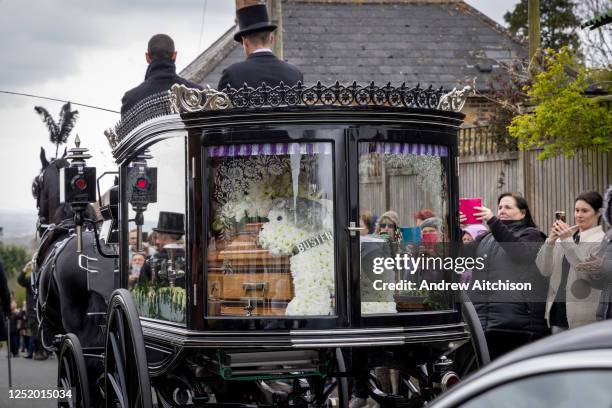 Paul O'Gradys husband Andre Portasio and their pet dog led the funeral procession sitting on the front of the horse drawn hearse through Aldington,...