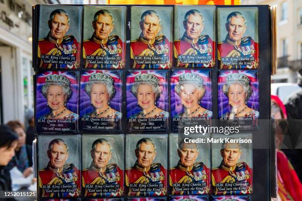 Souvenir fridge magnets featuring images of King Charles III and Queen Elizabeth II are displayed outside a gift shop on 20 April 2023 in Windsor,...