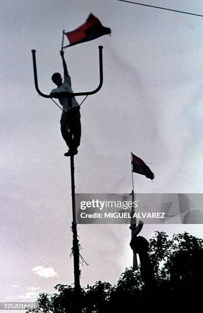 Sandinista sympathizer shakes a flag 27 November 2000, in the streets of Managua, to demand the results municipal selections of past 05 November.The...