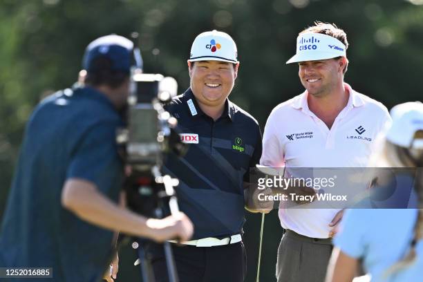 Sungjae Im of South Korea and Keith Mitchell at the 16th green uring the first round of the Zurich Classic of New Orleans at TPC Louisiana on April...