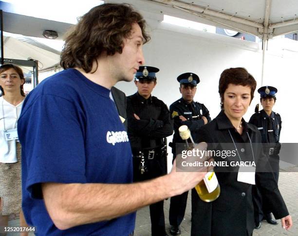 Members of Greenpeace are seen offering bottles to participants of the 18th Worldwide Energy Congress in Buenos Aires, Argentina 25 October 2001....