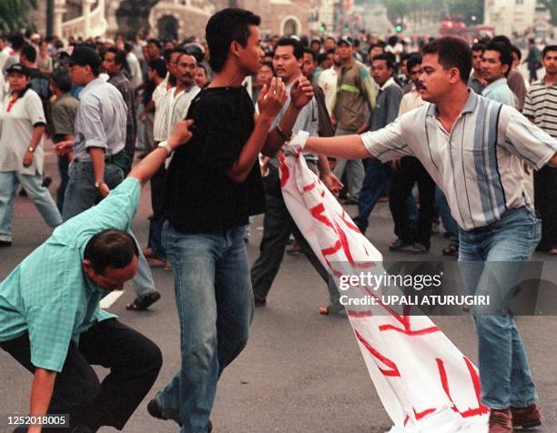 Two plain clothes policemen arrest a demonstrator at a pro-Anwar gathering at the Merdeka Square in Kuala Lumpur 28 September. About 3,000...