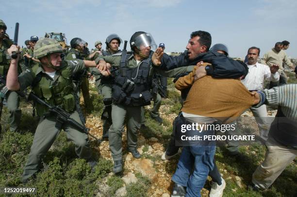 Israeli border police clash with residents of the West Bank town of Beit Surik as they try to prevent Israeli bulldozers from starting to work in a...