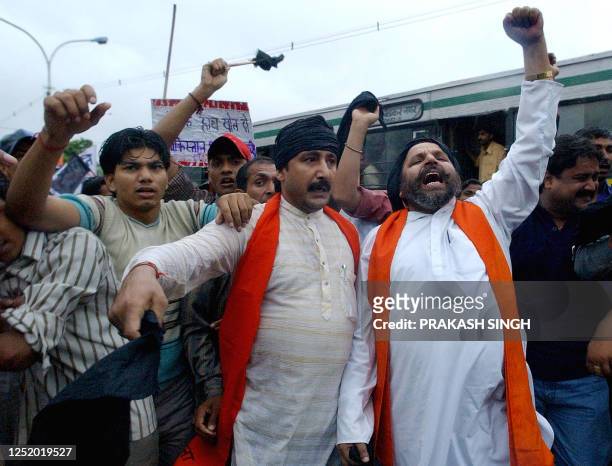 Shiv Sena acitivists shout slogans against the Delhi-Lahore bus service after its departure from Ambedkar terminal in New Delhi, 11 July 2003. The...