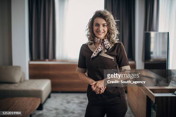 portrait of a happy chambermaid in hotel room - hotel occupation stock pictures, royalty-free photos & images