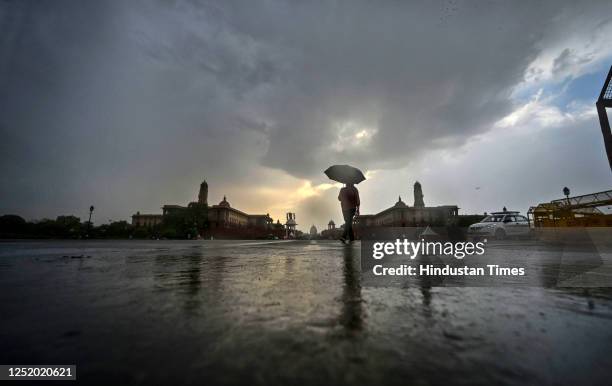 Tourist enjoying at Vijay Chowk during light rain on April 20, 2023 in New Delhi, India.