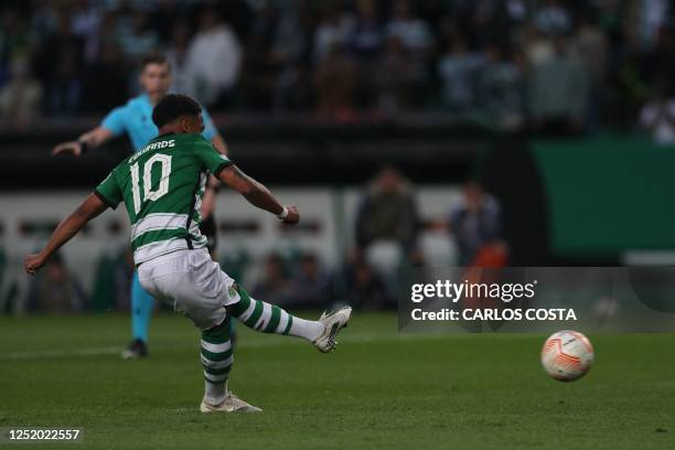 Sporting Lisbon's English forward Marcus Edwards kicks the ball to score his team's first goal during the UEFA Europa league quarter final second leg...