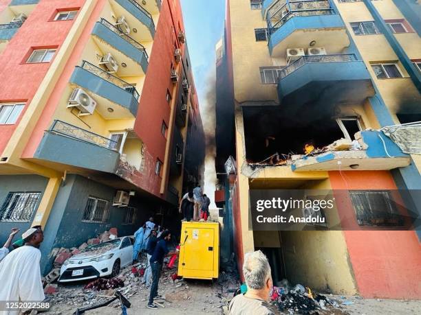 View of the area as a fire broke out after a house was hit in the Lamab district during clashes between the Sudanese Armed Forces and the...