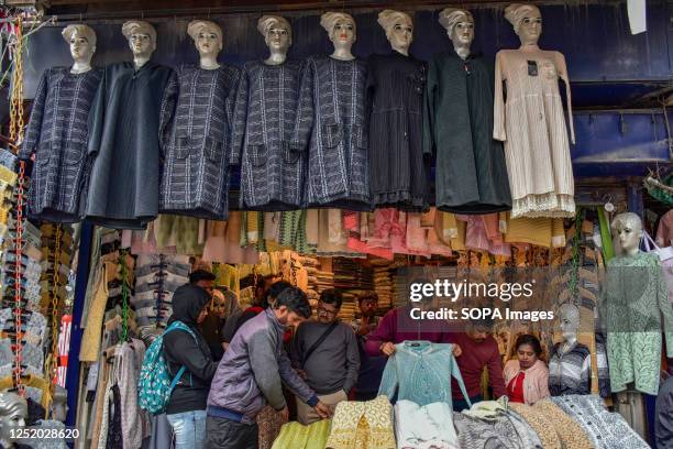 Kashmiri Muslims shop for clothes ahead of the Muslim festival Eid al-Fitr at a local market in Srinagar. Markets across the Muslim world witness...