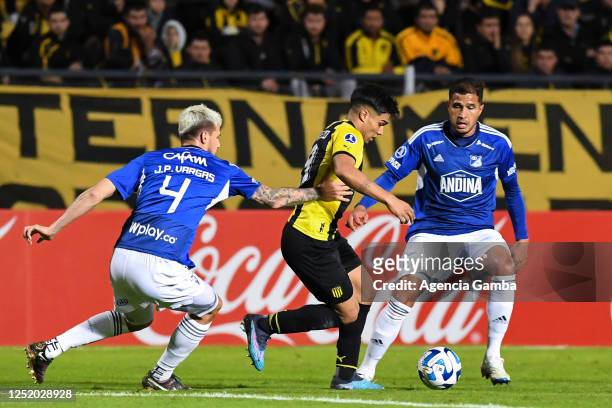 Juan Pablo Vargas of Millonarios and Matias Arezo of Peñarol fight for the ball during the Copa CONMEBOL Sudamericana 2023 group F match between...