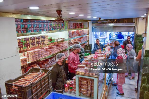 Kashmiri Muslims shop at a bakery store ahead of the Muslim festival Eid al-Fitr in Srinagar. Markets across the Muslim world witness huge shopping...