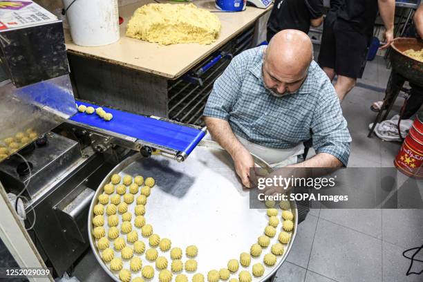 Maamoul cake maker prepares cakes, traditional Ramadan cakes, ahead of Eid al-Fitr in Jerusalem. Eid al-Fitr is a holiday in which Muslims celebrate...